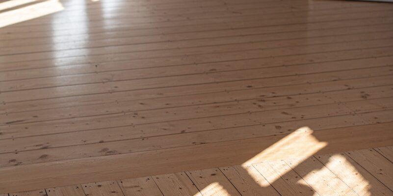 a wood floor with a white door